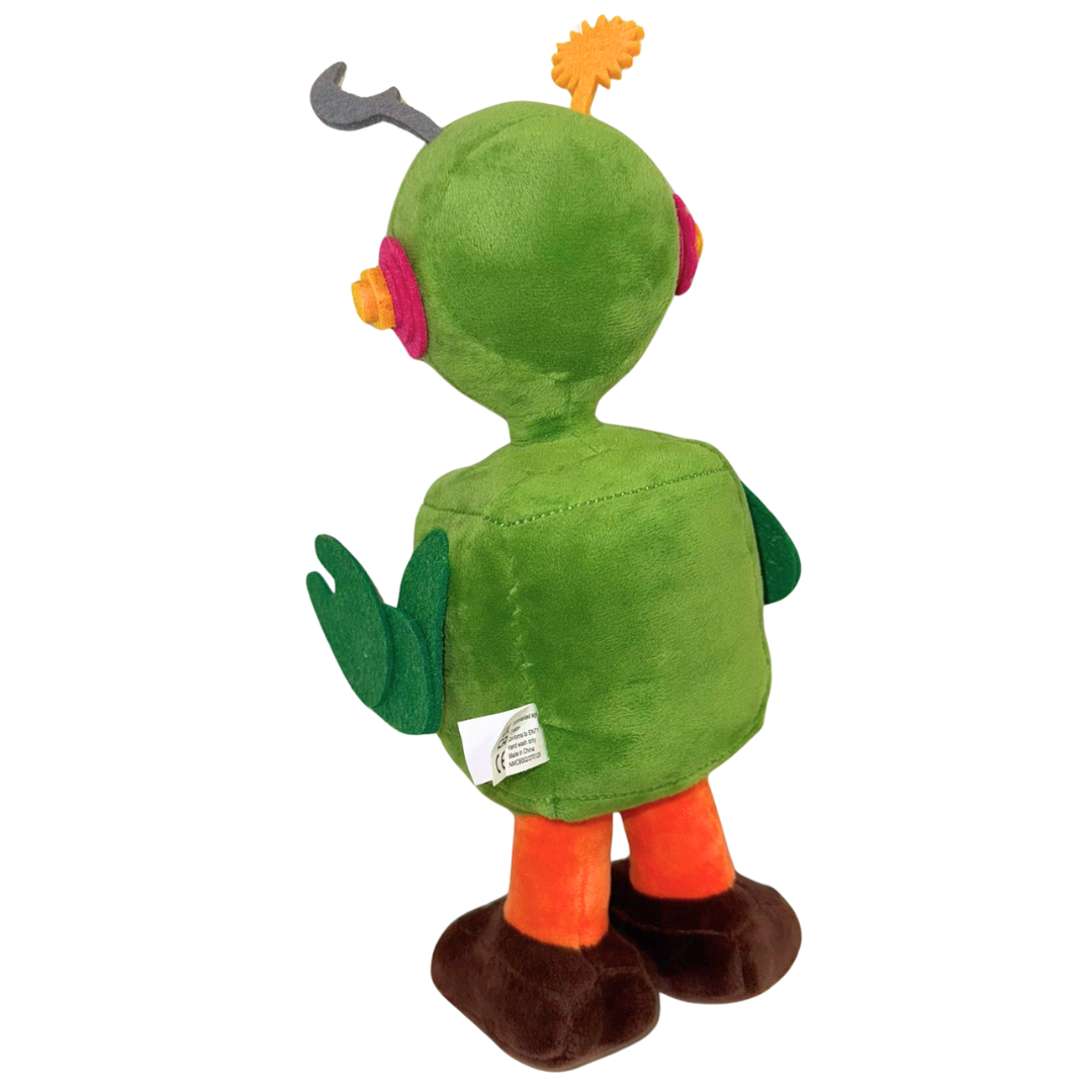 The Camp Bestival Earth-Bot Plush by 2025 features a green robot with antennae, round pink ears, green arms, a rounded body, orange legs, and brown feet standing upright and facing away from the camera.
