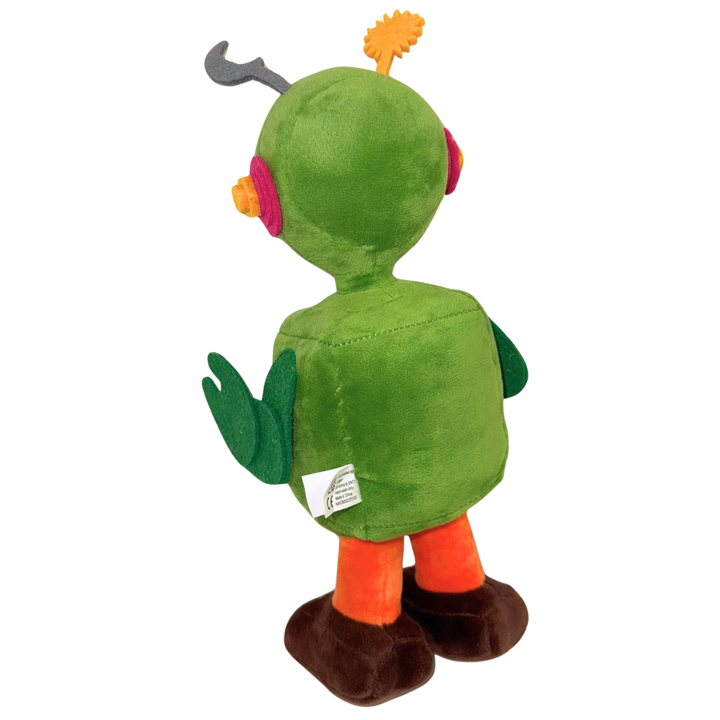 The Camp Bestival Earth-Bot Plush by 2025 features a green robot with antennae, round pink ears, green arms, a rounded body, orange legs, and brown feet standing upright and facing away from the camera.