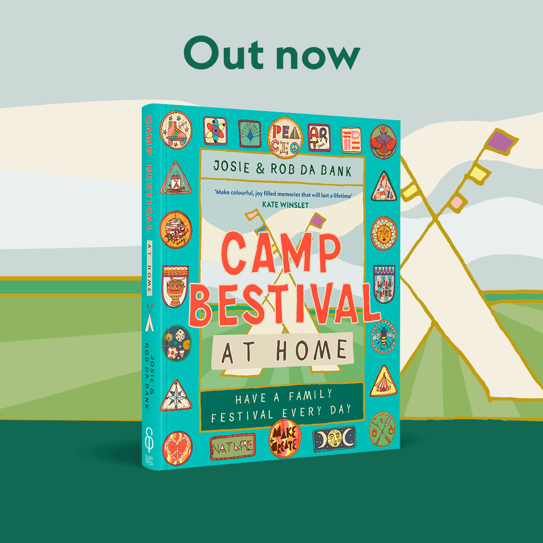 The Camp Bestival At Home Book by Camp Bestival stands upright against a backdrop of illustrated tents and a field. Out now, this vibrant festival handbook is full of fun family activities to enjoy together.
