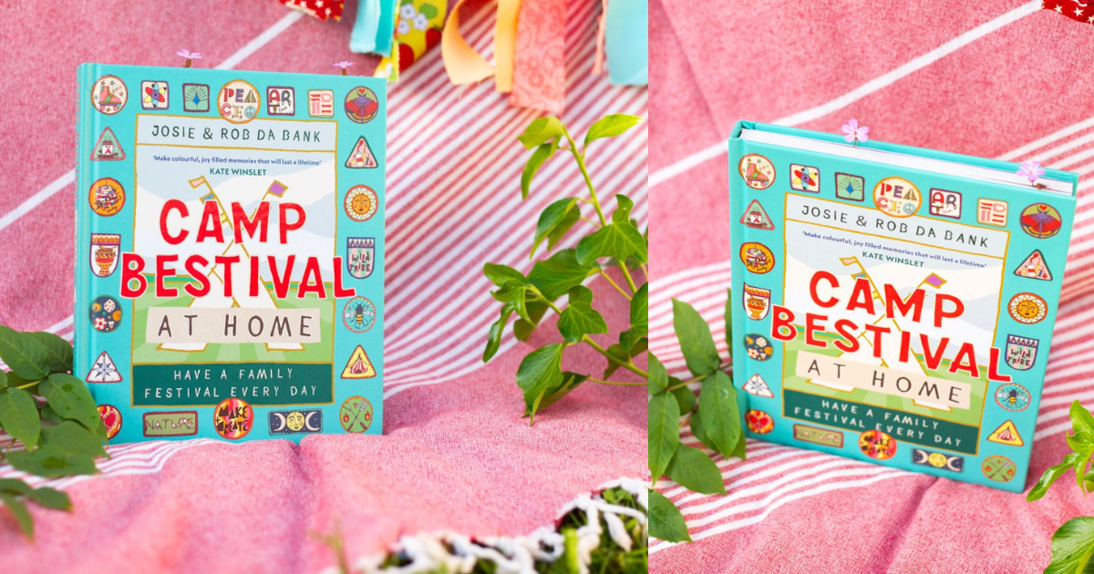 A book titled Camp Bestival at Home: Have a Family Festival Every Day by Josie & Rob Da Bank sits on a pink and white striped blanket outdoors, surrounded by green leaves and colorful decorations.
